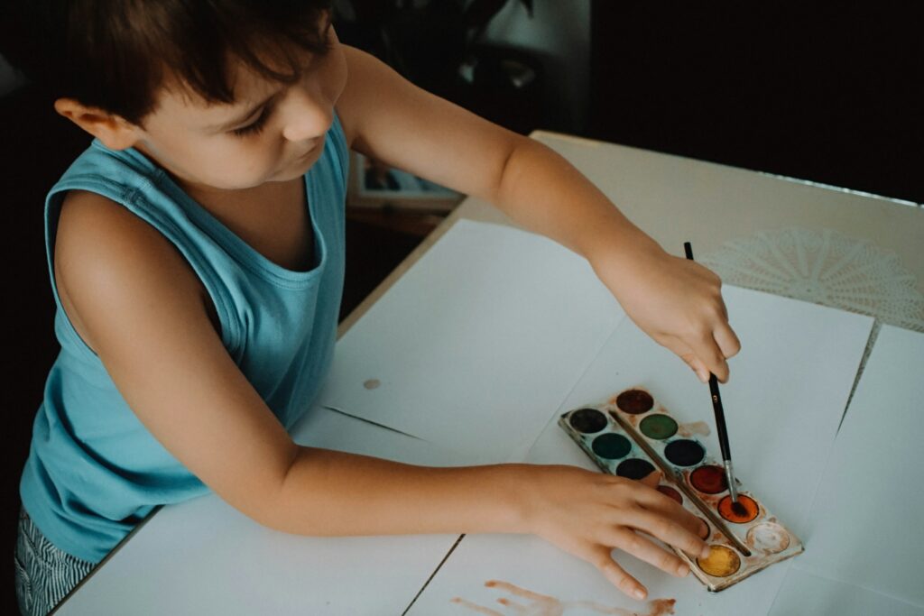 A boy using water colours