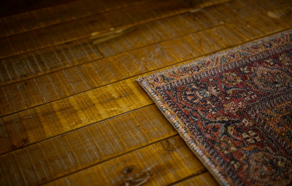 Close-up of an area rug on a wooden floor in a modern home interior