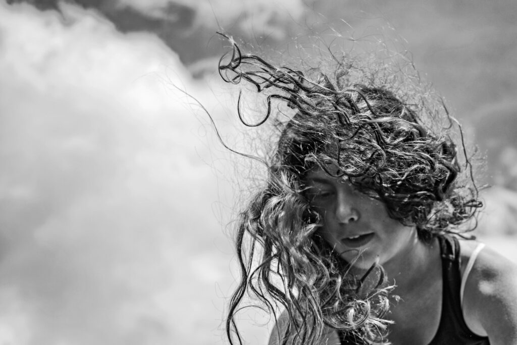 Grey scale photo of a woman with curly hair