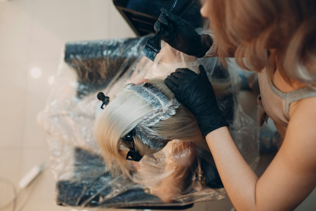 A Woman in a salon getting deep hair care treatment with a hairdressing mask