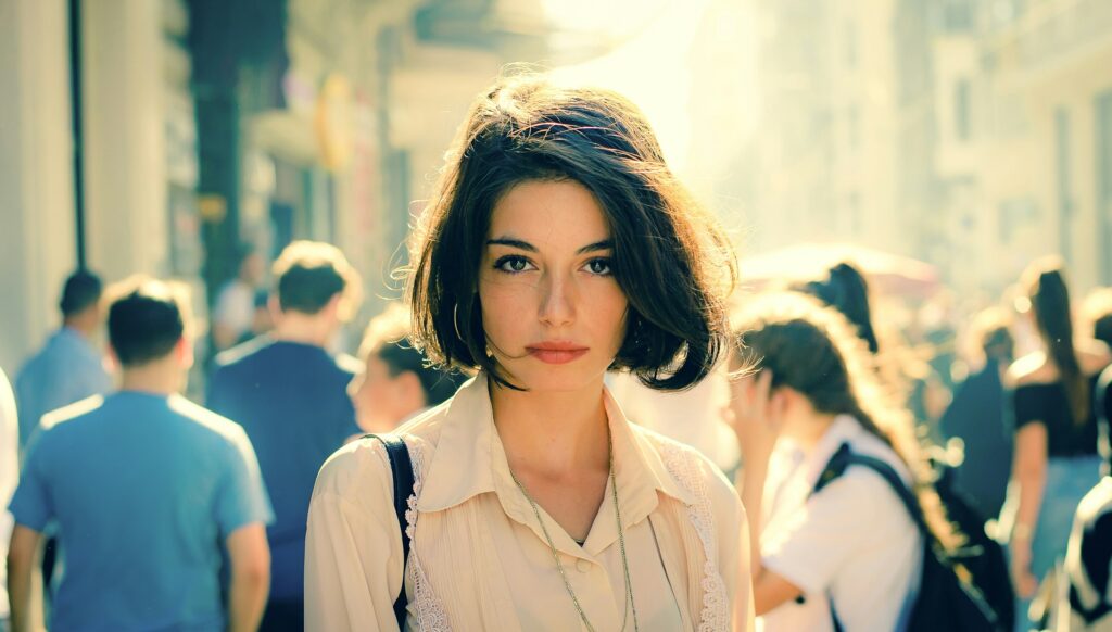 A woman with a bixie haircut walking in the street