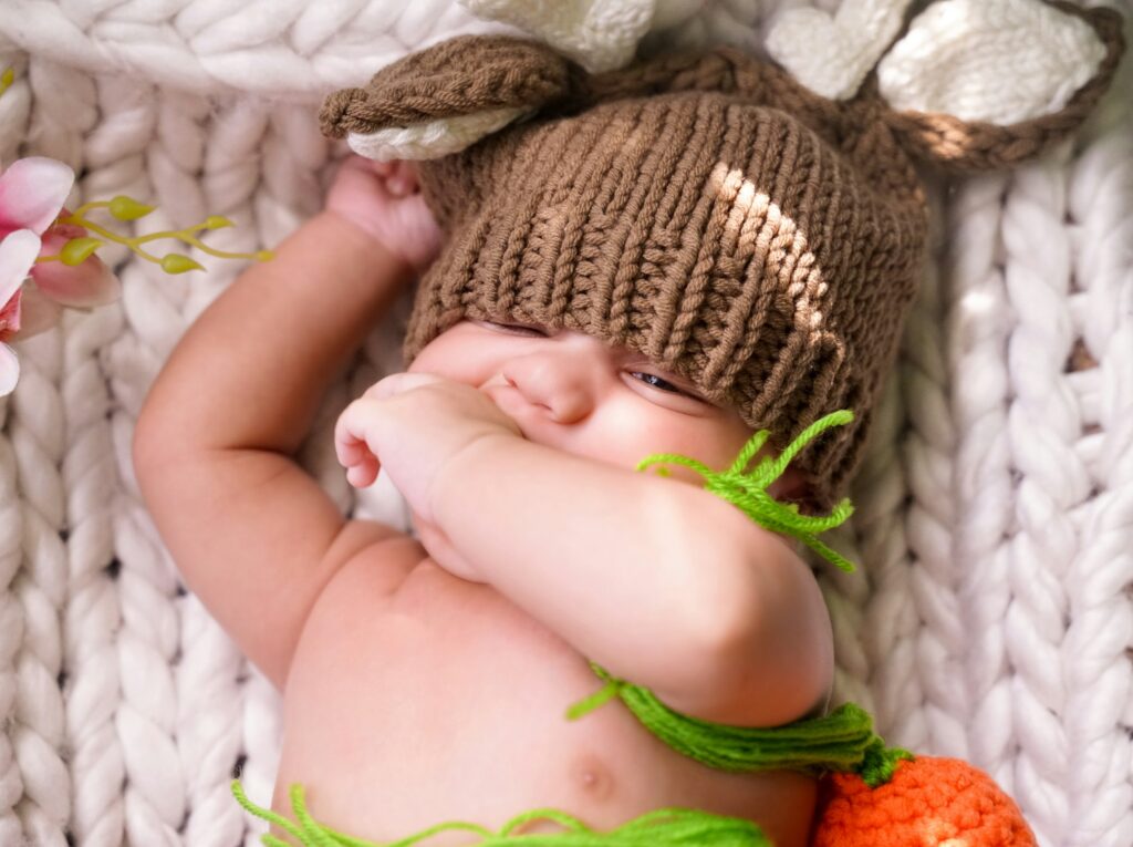 An infant wearing a baby bonnet
