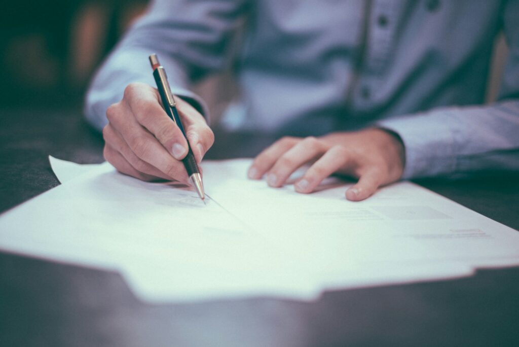 Property damage lawyer reviewing documents and preparing a claim at a desk.