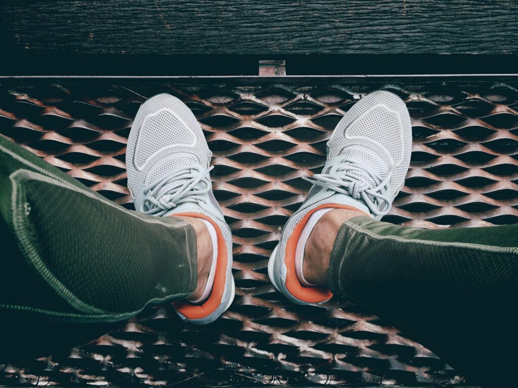 Tretorn sneakers styled with cropped pants on a city street for an effortlessly elevated casual look.