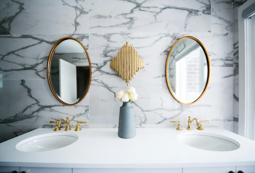 Modern small bathroom with white ceramic sink and neutral bathroom wallpaper, styled in a minimalist design.