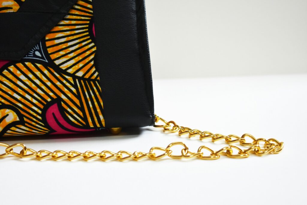 Close-up of a stylish bag with a chain strap, evoking the edgy look of a wallet chain as a modern fashion accessory.