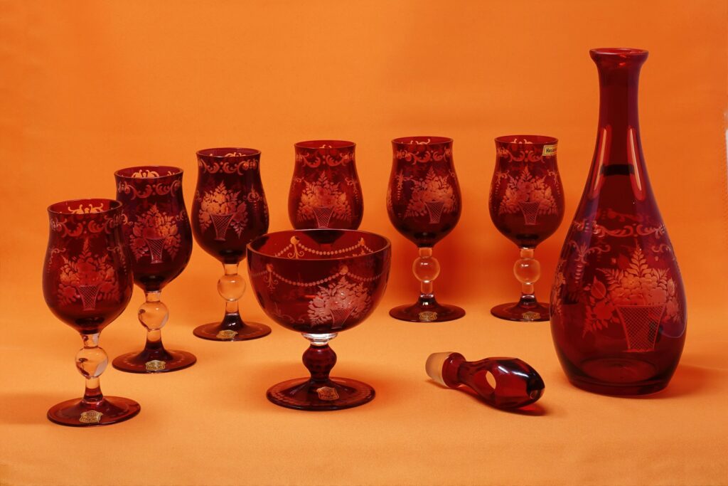 Elegant glassware sets JoyJolt featuring matching red wine glasses and a decanter on a white table.