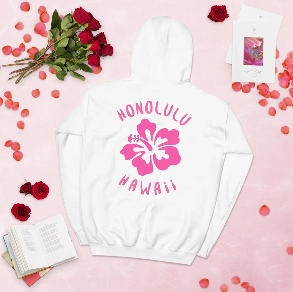 White preppy hoodie with pink Honolulu Hawaii graphic, styled with roses, books, and aesthetic stationery on a soft pink background.