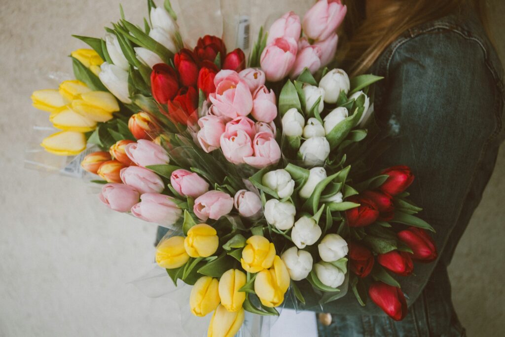 Woman holding a tulip bouquet for weddings and events. 
