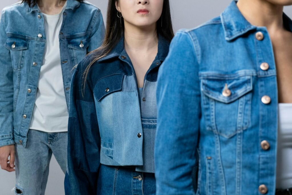 Group wearing denim-on-denim Y2K outfits, featuring jackets and jeans styled in a modern early 2000s look.