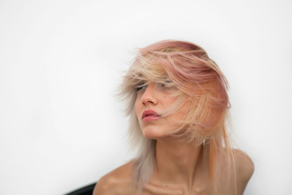 woman with wispy bangs and textured layered hair.