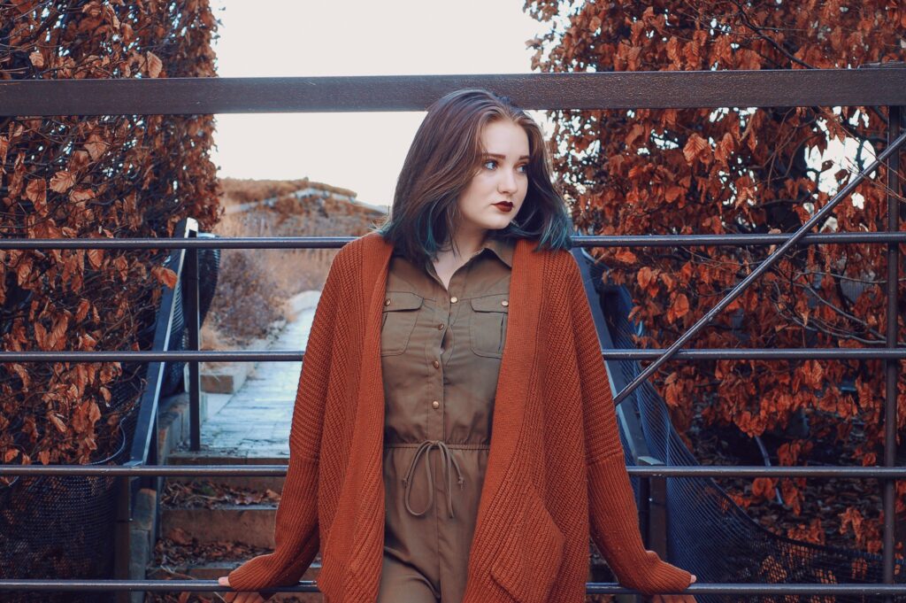 Deep autumn color palette outfit featuring rust cardigan and olive dress styled with warm earthy tones.