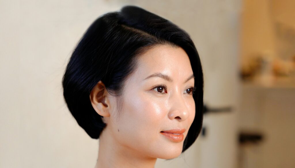Close-up of a woman with luminous, glowing glass skin achieved through consistent Korean skin treatment and K-beauty skincare routine
