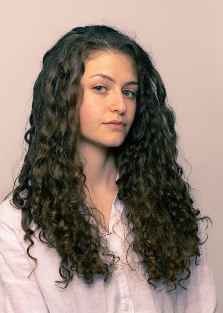 Long defined spiral curls showcasing a healthy natural curly hairstyle with soft volume.