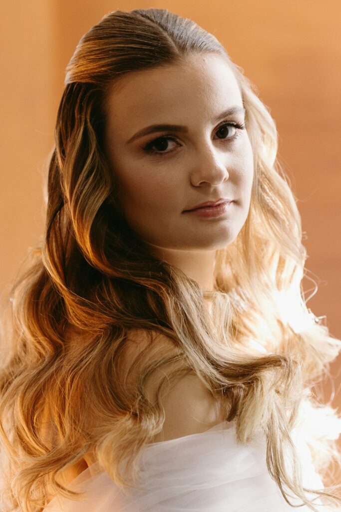 Classic Hollywood waves hairstyle with soft glamorous curls and a side-parted finish.