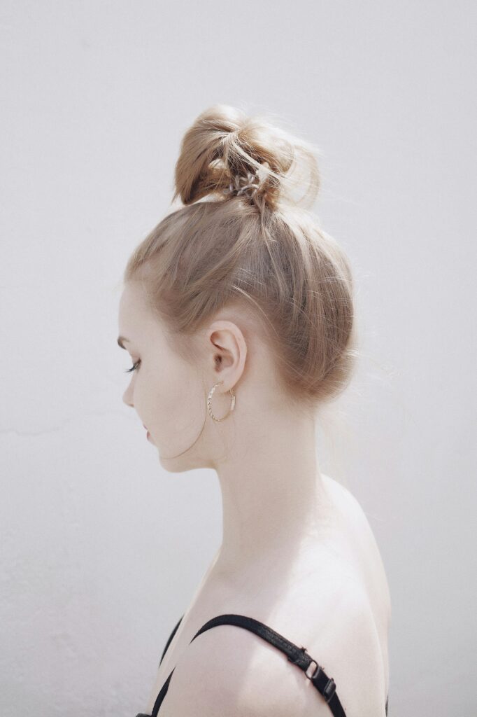 Elegant loose top knot hairstyle with soft face-framing strands for an effortless everyday look.