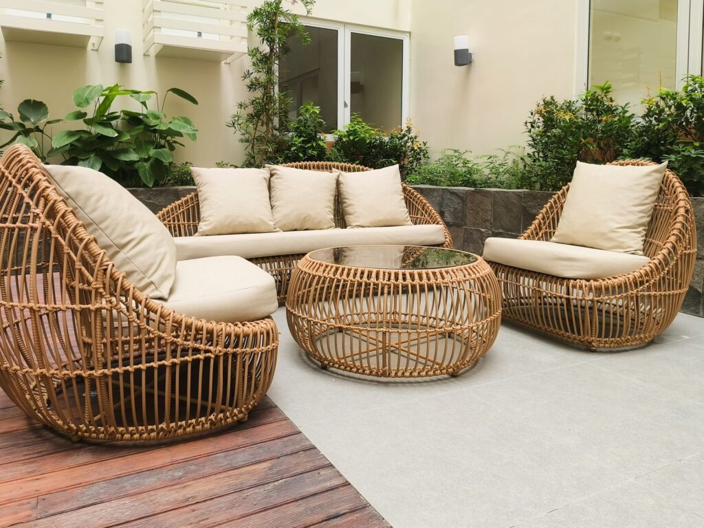 Woven rattan lounge chairs and coffee table set on an outdoor patio.