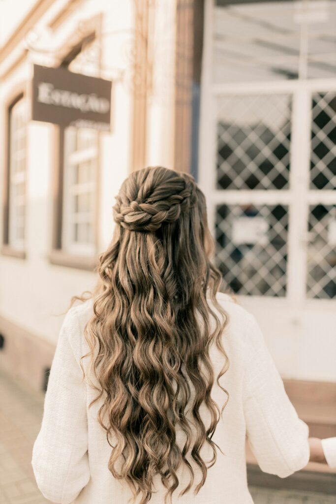 Beautiful waterfall braid hairstyle on long wavy hair viewed from the back.