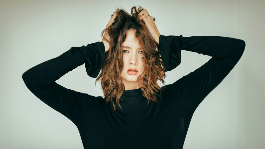 Woman with a textured long shag haircut and choppy layers.