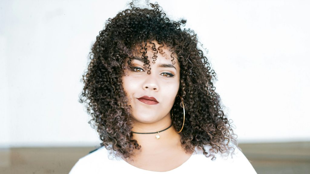 Close-up of tightly coiled, well-defined curly hair with visible ringlet pattern.